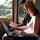 red hair with laptop sitting in train home