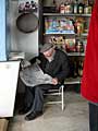 old man reading his paper in his little shop in Sardegna that is now run by his son